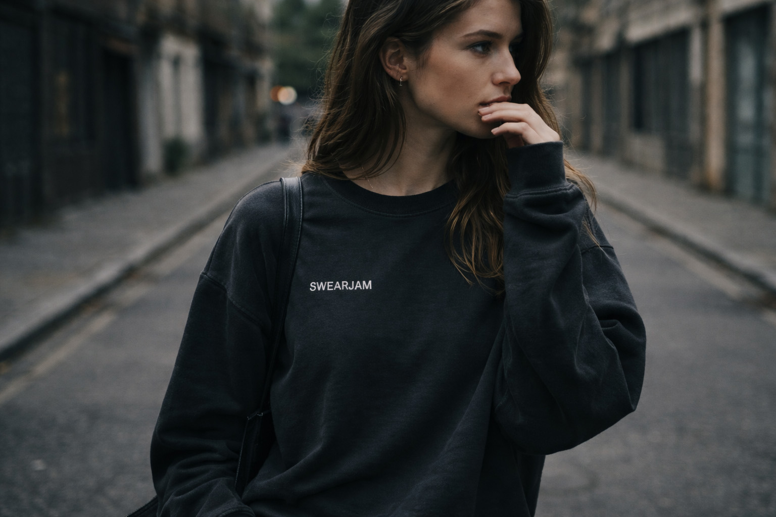Swearjam washed black sweatshirt with small chalk-white SWEARJAM wordmark at chest